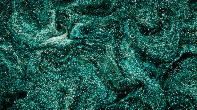 Abstract spheres swirling around like paint.