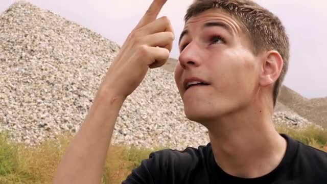 Boy spinning a soccer ball on his finger then head.