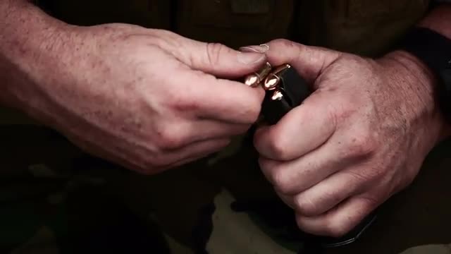 Soldier loading a pistol magazine