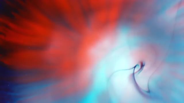 Swirl of color mixing as drop of blue splatters