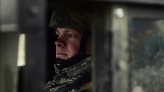 Shot of soldier sitting in a Humvee.