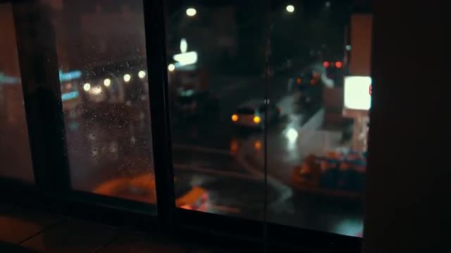 Handheld shot of a busy city street corner during a storm.