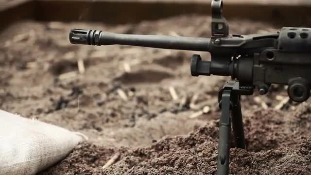 Soldier shooting machine gun while on his stomach