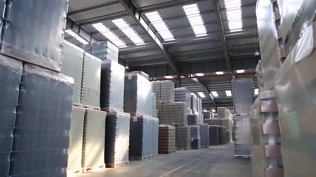 Packing of bottles in workshop of glass factory.