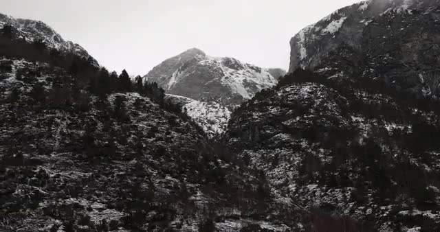 Video shot from boat over fjord at sunset with snowy mountains