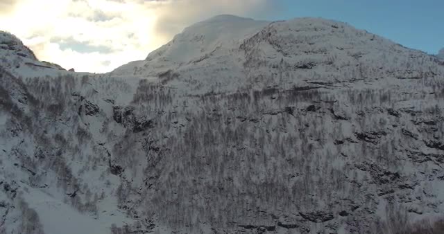 Aerial shot of amazing landscape on a sunny day with snowy mountains in view