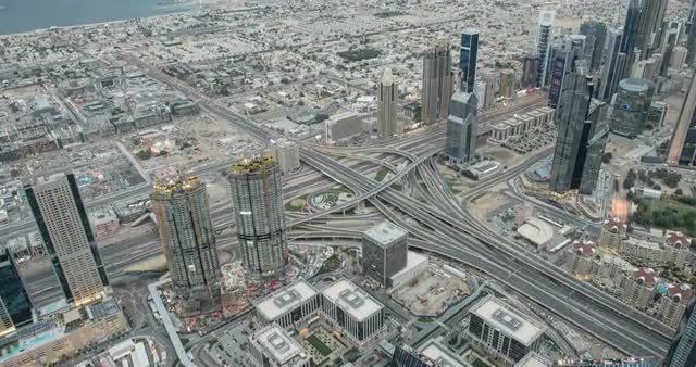 Timelapse from viewpoint at sunset with cityscape, traffic and huge junction