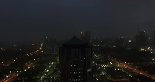 Aerial shot over Shanghai Science and Technology Museum at night 
