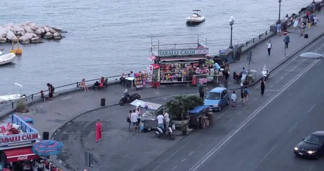 Video shot of Naples Bay on a sunny day with harbor and people in view