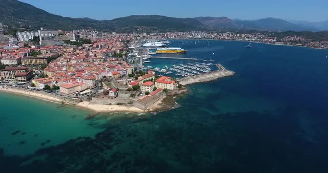 Aerial shot of Bastia cityscape on a sunny day with harbor and sea in view
