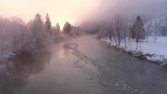 Flying over the Soca River as the sun lights up the foggy mist