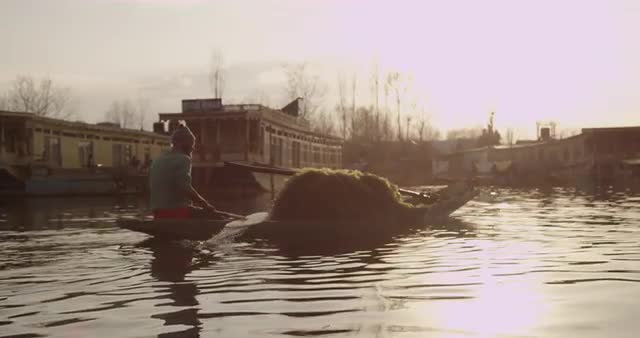 Man Paddling Through Village