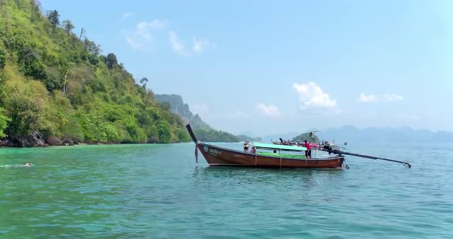 Classic motorboat, guiding tourists off the coast of Krabi.