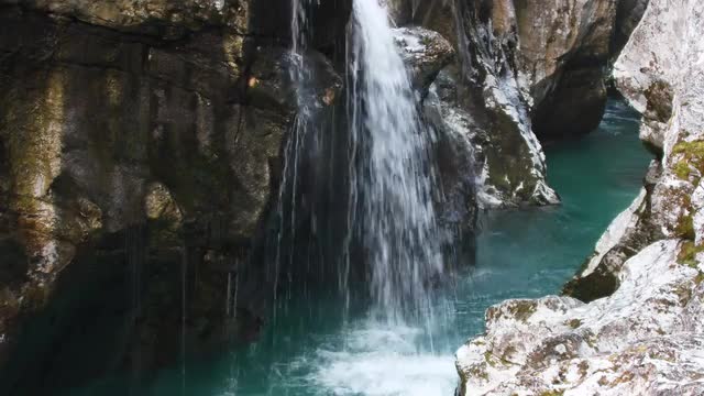 Waterfall in a gorge carved into the rock on the Soca river, Julian Alps in Slovenia, Europe
