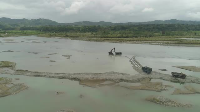 Cleaning and deepening by a dredger on the river. Philippines, Luzon
