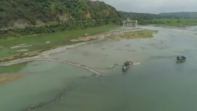 Cleaning and deepening by a dredger on the river. Philippines, Luzon