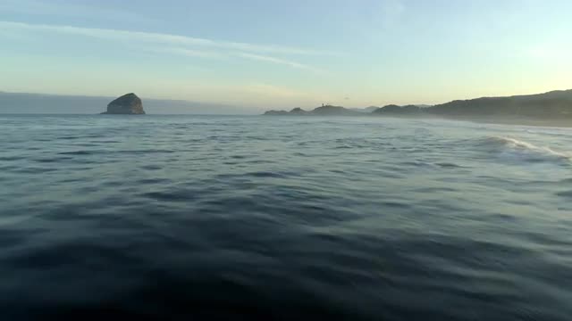 Wide aerial shot of coast line and waves
