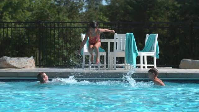 Girl jumping into pool in super slow motion Girl jumping into pool in super slow motion