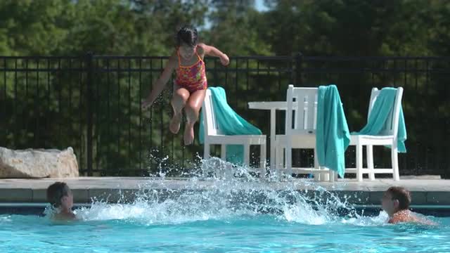 Girl jumping into pool in super slow motion Girl jumping into pool in super slow motion