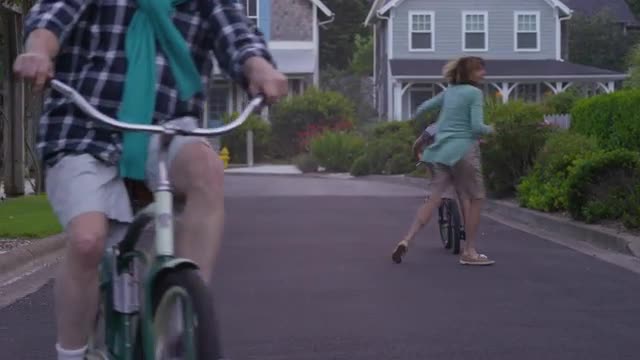 Grandparents riding bikes with grandson