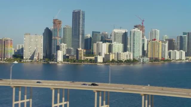Tracking along cauesway with downton Miami, Florida in background