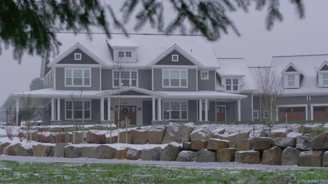 Country home in winter storm with snow falling