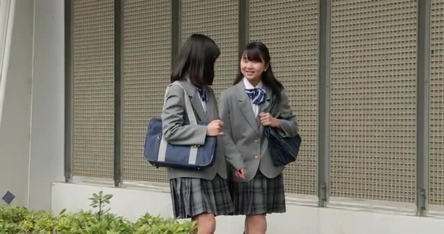 Japanese school students walking downtown Tokyo