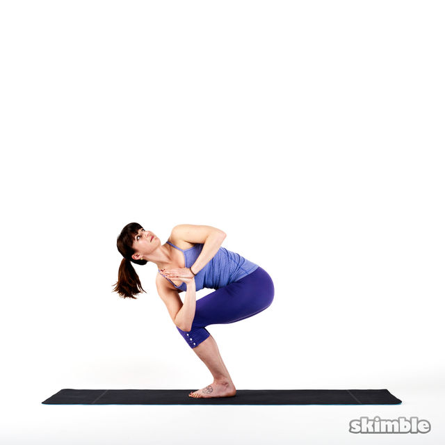 Left Twisted Chair Pose Exercise Howto Workout Trainer by Skimble