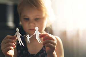 child holding paper dolls
