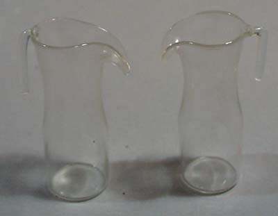 Pair of glass creamers or childs coffee pot