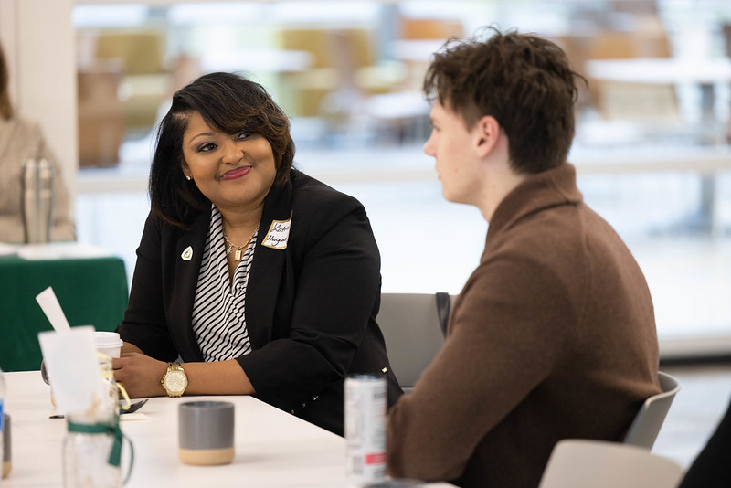 Photo of a mentor with mentee at a table