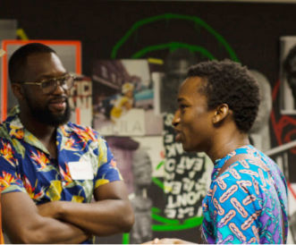 Two men in blue chatting