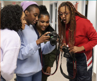 Four women looking at camera