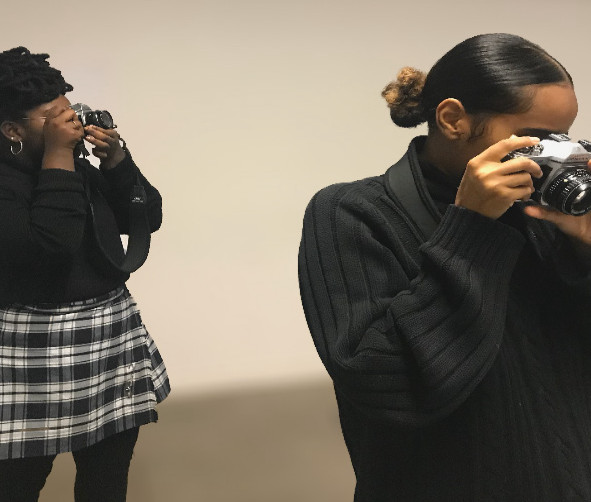 Two photographers taking photos in a gallery