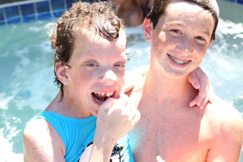 A couple of boys in a pool AI-generated content may be incorrect.