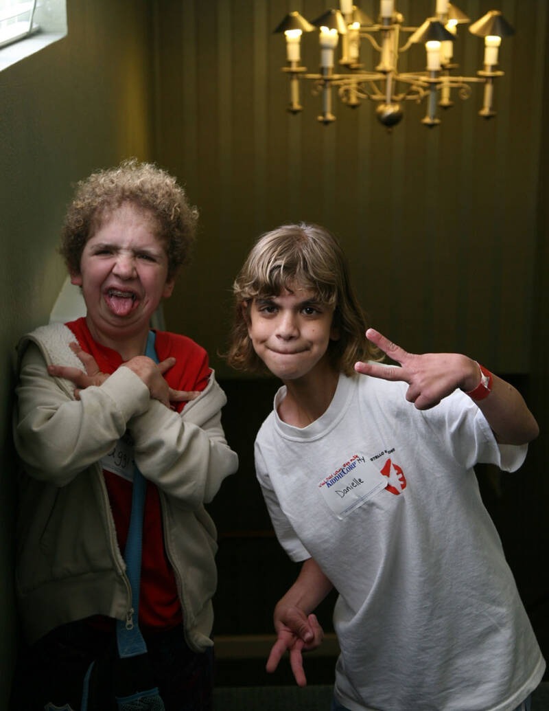 A couple of kids making faces AI-generated content may be incorrect.