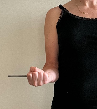 A person holding a metal object AI-generated content may be incorrect.