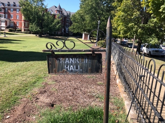 A sign on a fence Description automatically generated