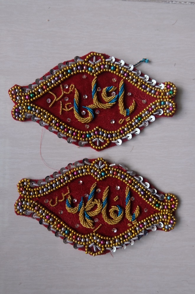 A pair of embroidered patches AI-generated content may be incorrect.