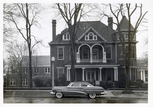 A car parked in front of a house Description automatically generated