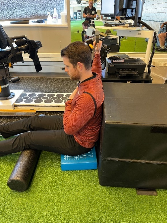 A person sitting on a bench Description automatically generated