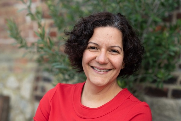 A person smiling at camera Description automatically generated