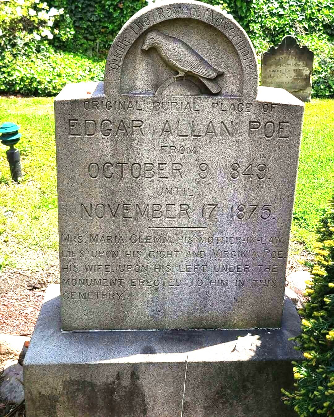 A tombstone in a cemetery Description automatically generated