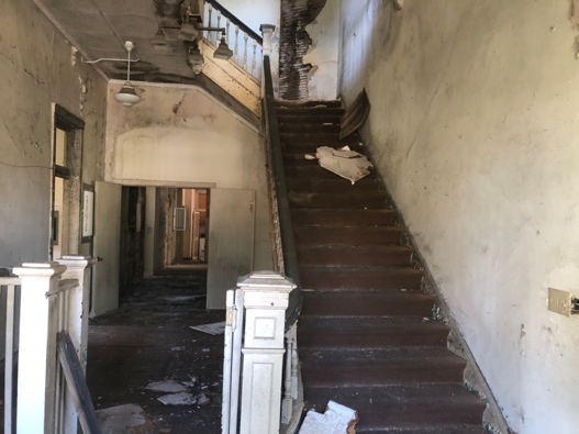 A staircase with a broken down staircase Description automatically generated with medium confidence