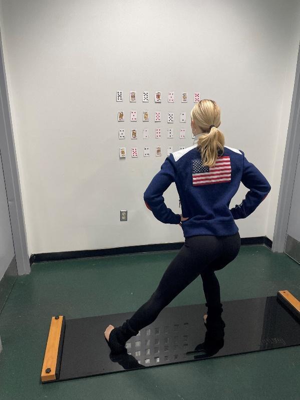 A person standing on a treadmill Description automatically generated