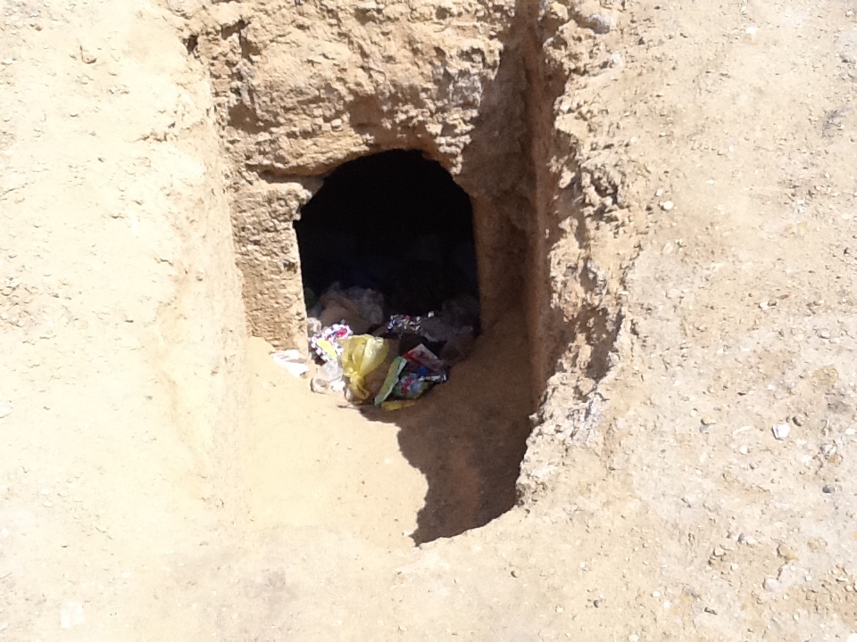 A hole in the ground with trash in it AI-generated content may be incorrect.