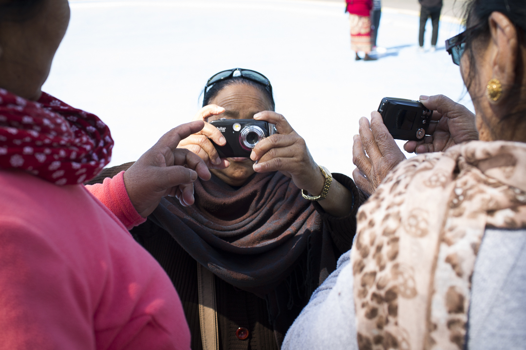 A group of people taking pictures Description automatically generated