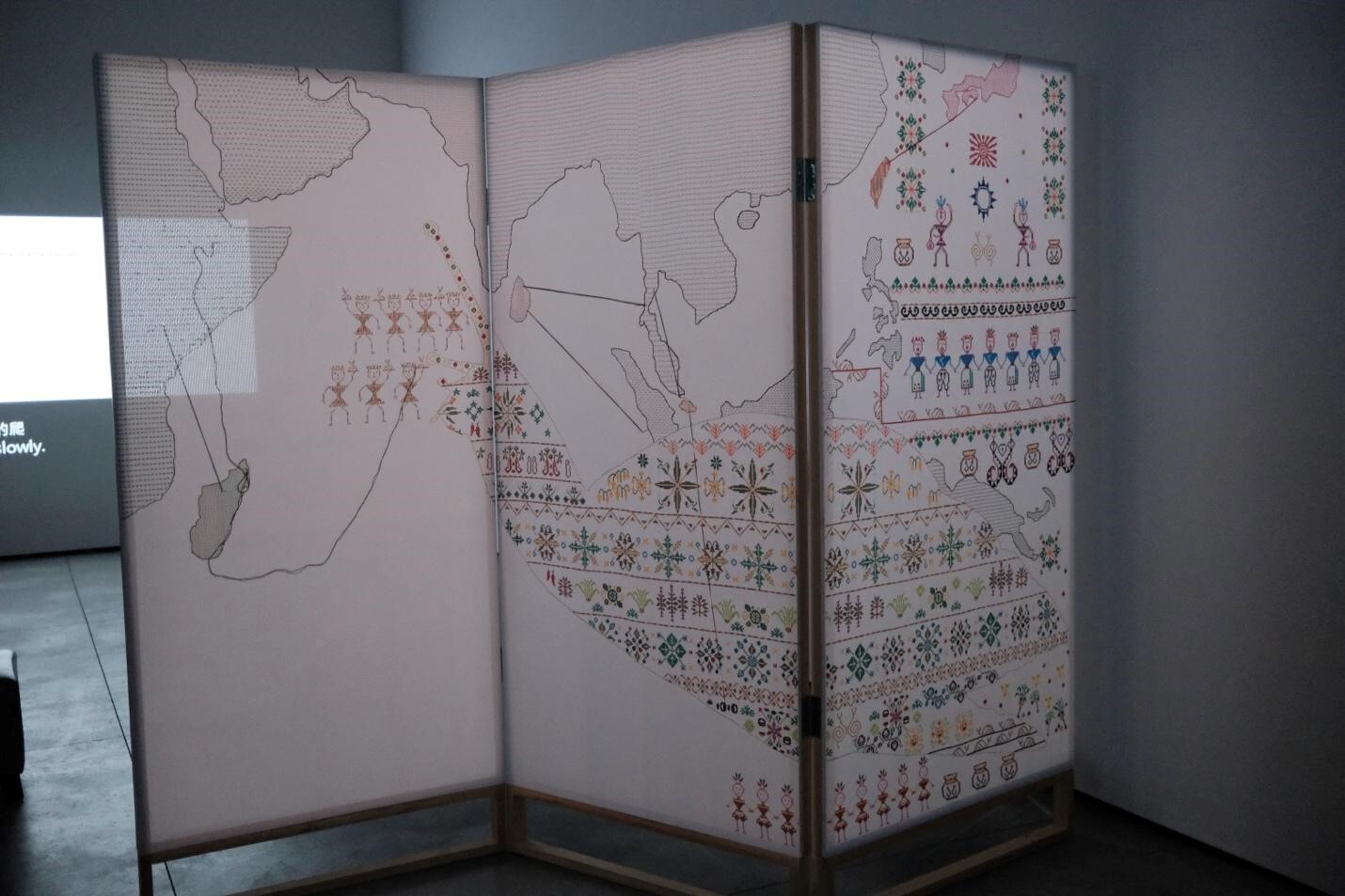 A screen with a map of the world Description automatically generated