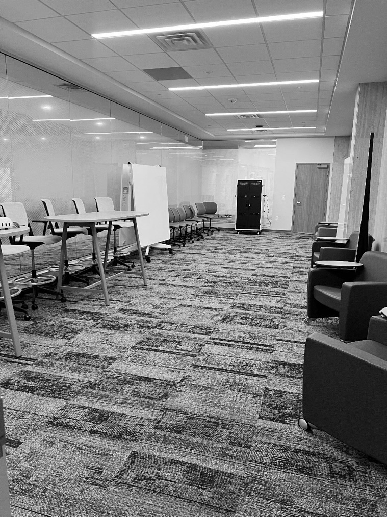 A room with chairs and tables AI-generated content may be incorrect.