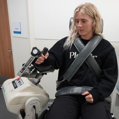 A person sitting on a machine AI-generated content may be incorrect.
